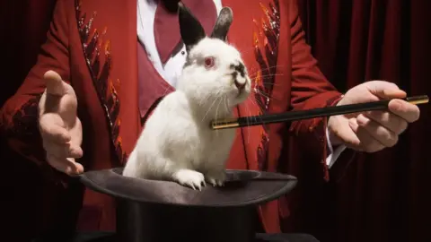 Getty Images A rabbit is pulled from a magician's hat