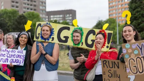 Great Manchester Run Supporters with various home-made posters and placards gives upport to the runners.