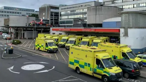 Getty Images A view of the Accident and Emergency Unit at the University Hospital Wales showing ambulances parked outside the Emergency unit together with one of the Welsh Air Ambulances on a rooftop helipad.