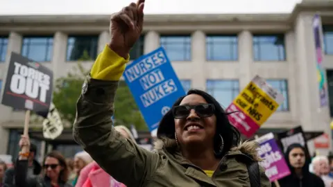 Getty Images Protesters chant and wave placards