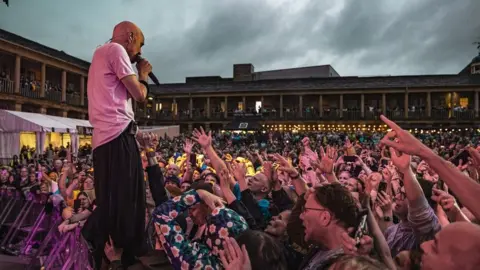 Cuffe and Taylor/The Piece Hall Tim Booth on stage with the crowd going wild