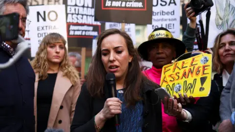 Reuters Stella Moris speaks to protesters