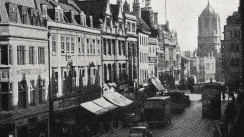 Oxford City Council  Cornmarket Street with vehicles using it in the 1940s, with Christ Church's Tom Tower in the background