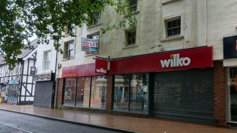An empty Wilko shop with shutters down