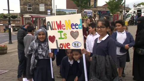 Children holding a banner