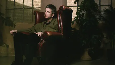 Matt Crockett Noel Gallagher sat in a leather chair