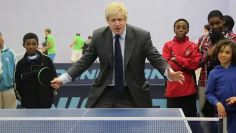 PA Boris Johnson playing ping-pong at a youth club