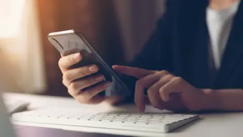 Getty Images person using mobile phone