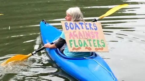 Little Blue Dot Boaters against floaters sign