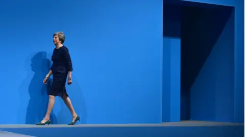 Jeff Overs/BBC Theresa May walks onto the conference stage