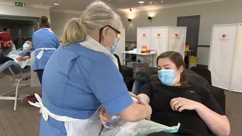 Dr Gemma Morgan, lecturer in Criminology at Swansea University, giving blood for the first time