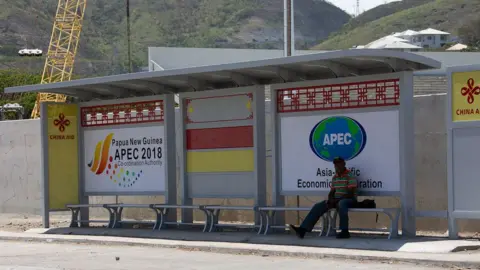 AFP Chinese aid branding and APEC ads on a bus stop in Port Moresby