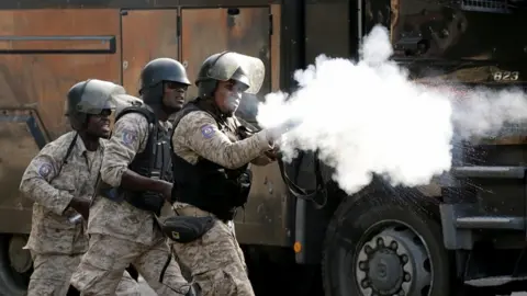 Reuters A member of security forces aims a weapon during a protest to demand the resignation of Haitian president Jovenel Moïse, in the streets of Port-au-Prince, Haiti October 11, 2019