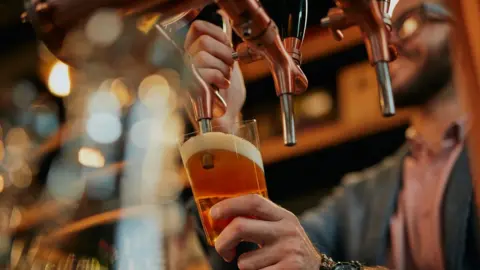Getty Images A man pouring a pint of beer