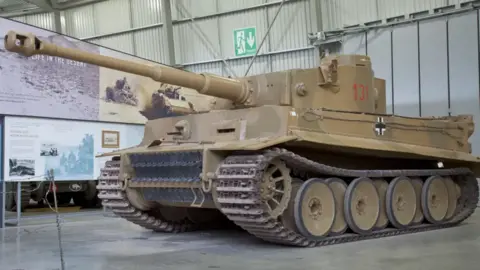 A picture of the camouflaged Tiger 131 tank in the Tank Museum. 
