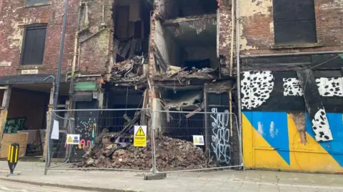 Exterior shot of some crumbling, derelict shop fronts in Leeds city centre.