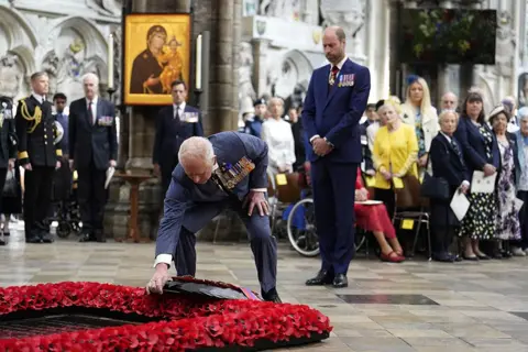 Jordan Pettitt/Pool via REUTERS King Charles lays a wreath at the grave of the Unknown Warrior during a service of thanksgiving at Westminster Abbey in London on the 80th anniversary of VE Day.