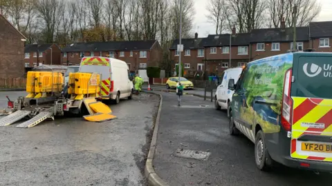 United Utilities vans on Gerrard Way as workmen in green high-vis try to deal with the flooding. 