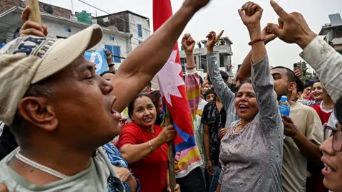 AFP via Getty Images Supporters of the Rastriya Swatantra Party (RSP) celebrate outside the counting centre at Damak in Jhapa district