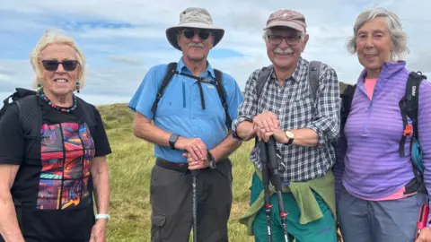 Ramblers Nancy and John Thirsk and Colin and Anne Darlington smiling at the camera on the Denbigh moors