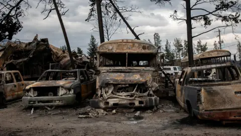 Reuters A general view of burnt buses and cars in Jasper, Alta., on Friday, July 26, 2024