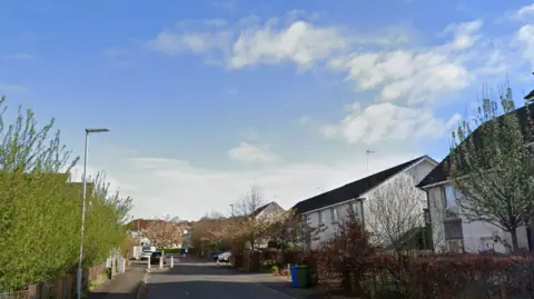 A view of a street with several houses on it