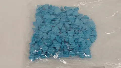 North East Regional Organised Crime Unit A clear bag filled with blue triangular pills