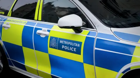 Getty Images A police car with a Metropolitan Police log and blue and yellow chequerboard pattern on the side 