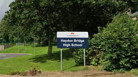 A schoolhouse motion connected writer stating 'Haydon Bridge High School' pinch 'Northumberland County Council' supra it.