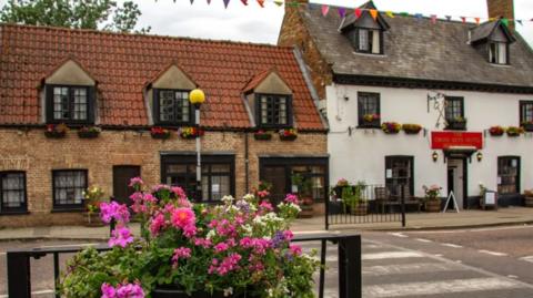 Flowers in front of historic buildings in Chatteris