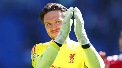 Liverpool goalkeeper Freddie Woodman applauds the crowd after the Merseyside derby
