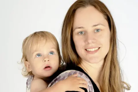 Lydia Campbell-Hill Dr Lydia Campbell-Hill carrying her son