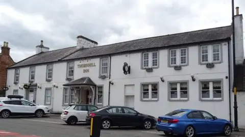 J Thomas Thornhill Inn - a white pub with cars parked outside