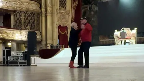 An elderly couple dance at the Tower Ballroom in Blackpool as someone plays an organ in the background.