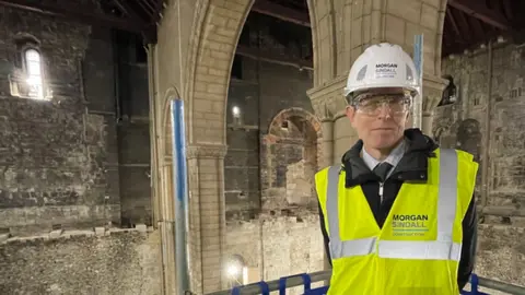 Mike Liggins/BBC Dr Robin Hanley in the under-construction keep of Norwich Castle