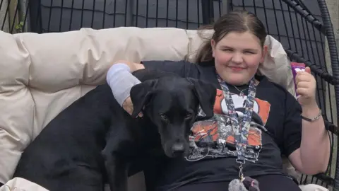 Jenni Leary Scarlette sat on a bench with her dog Ivanhoe 