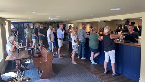 The Pleasure Boat Inn Queues of people at the pub