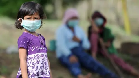 AFP A Balinese girl wears a mask