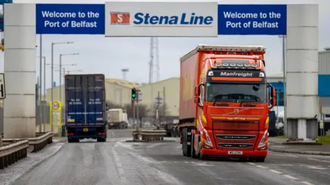 PA Media Freight lorries travelling through the Port of Belfast