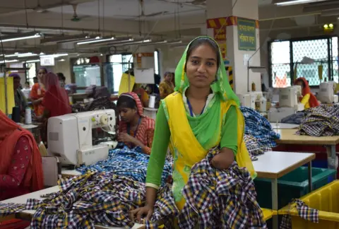 UCEP Bangladesh 25 year old Halima sits in front of her sewing machine.