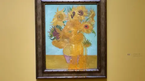 PA Media An representation  of Van Gogh's Sunflower artwork astatine  the National Gallery which has had herb  crockery   thrown implicit    it