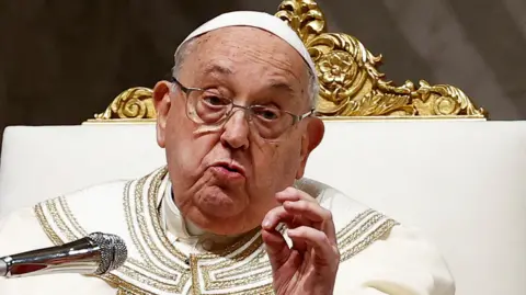 Pope Francis in white and gold vestments and glasses leading prayers at Saint Peter's Basilica at the Vatican at the beginning of February