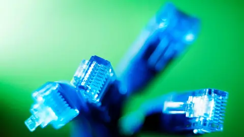 four blue ethernet cables against a green background