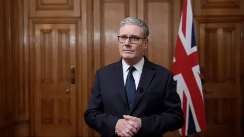 Keir Starmer in front of a union jack flag