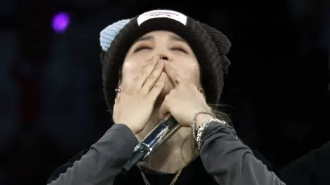 Jimin of BTS blows a kiss to fans during the band's show at Tottenham Hotspur Stadium