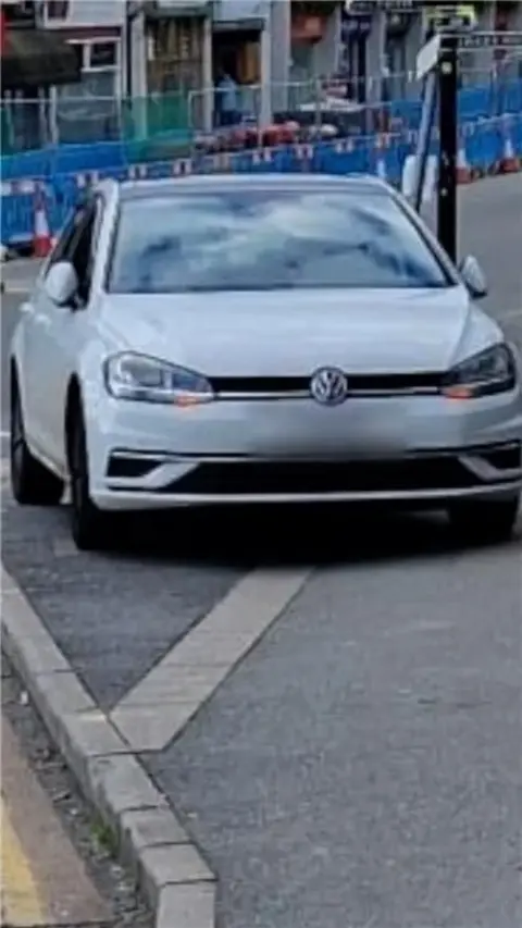 A car parked on a pavement.