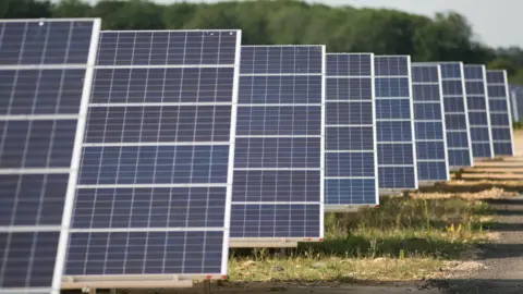 PA A close up image of solar panels on the ground
