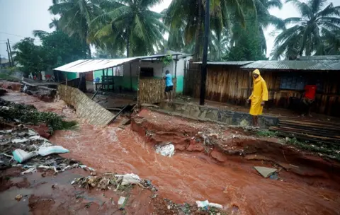 Reuters A man walks past flood damaged houses in the aftermath of Cyclone Kenneth in Pemba, Mozambique