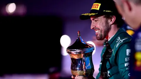 Fernando Alonso celebrates on the podium