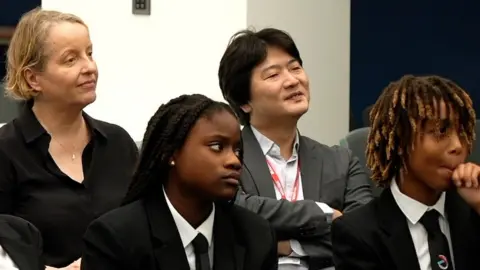 BBC/Neil Paton CBSO chief executive Emma Stenning [L] with chief conductor Kazuki Yamada and pupils